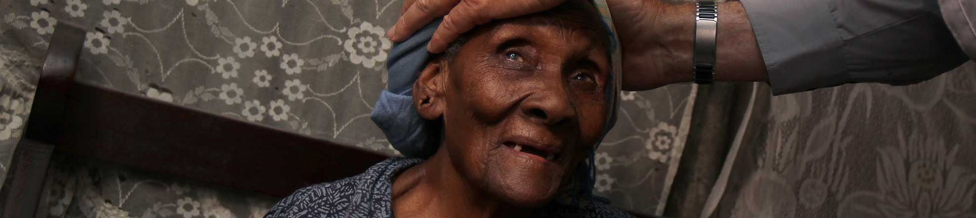 a woman with priests hands on her head