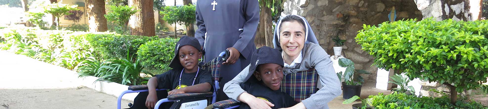 nuns with children in wheelchairs