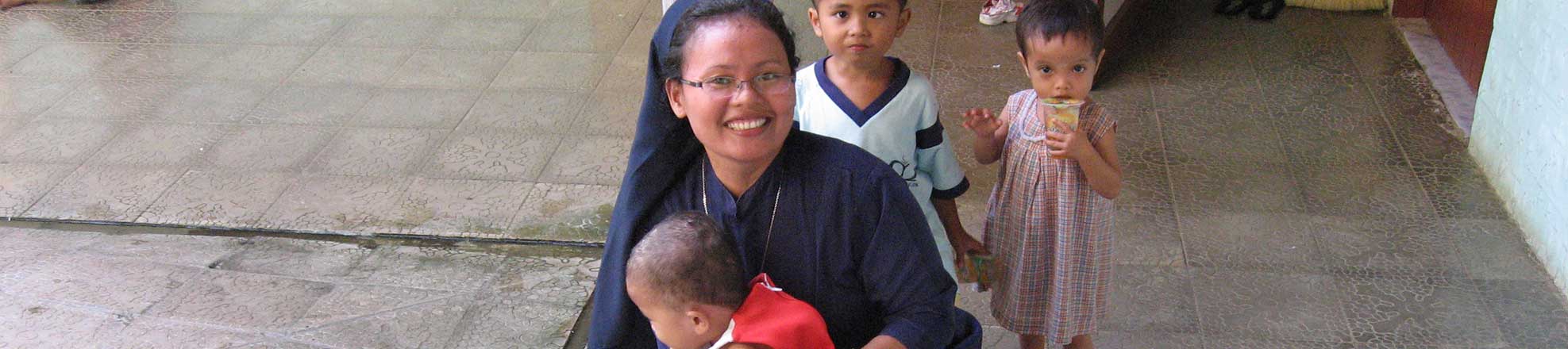 A nun with children in Asia