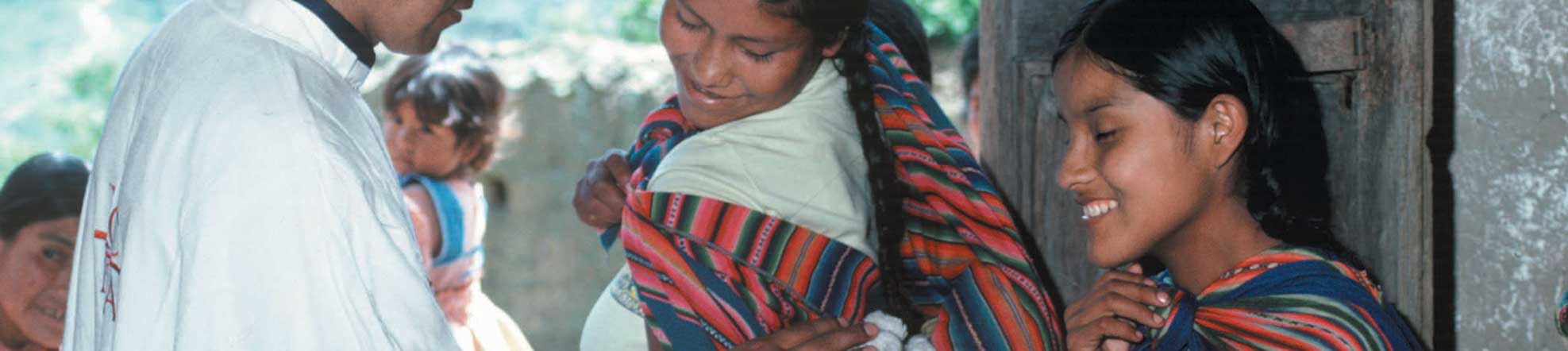 mother with a baby and a priest