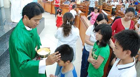 child getting baptized in Asia