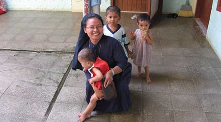 A nun with children in Asia