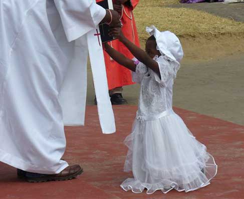 small child with a priest